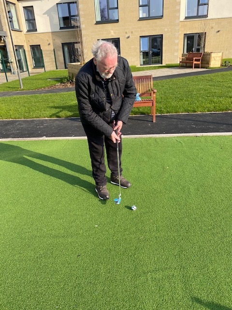 Resident Playing Golf in Roselea Court Grounds