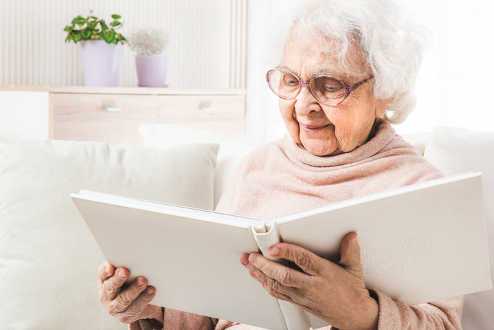 older woman looking through photo albums 