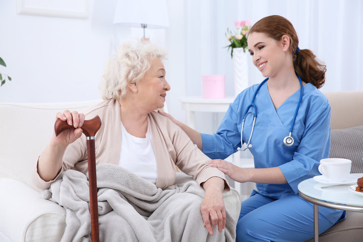 nurse smiling at resident in care home
