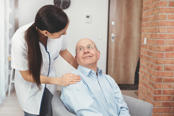 older man with nurse in care home