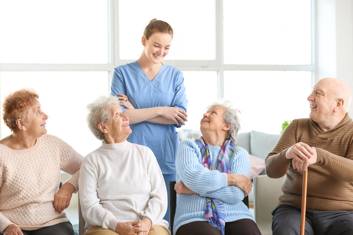 nurse smiling at resident in care home