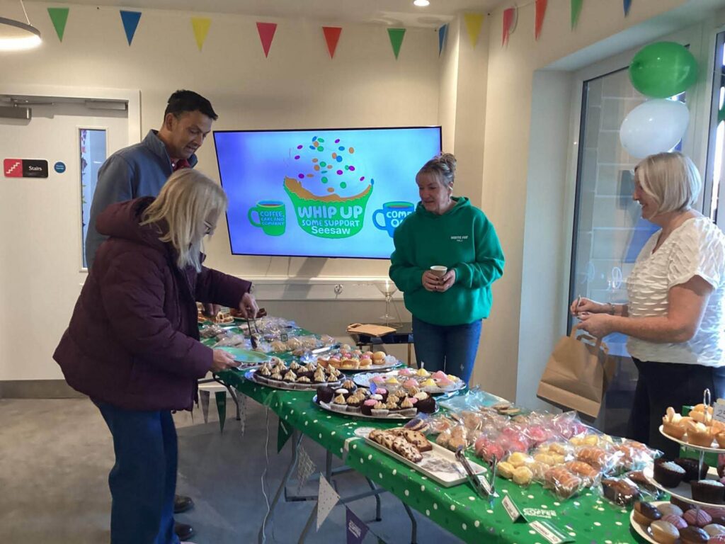 staff serving guests for macmillan coffee morning